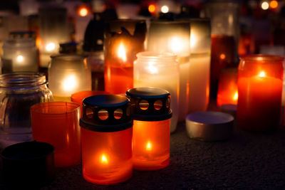 Illuminated candles on table at night