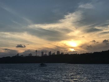 Scenic view of silhouette city against sky during sunset