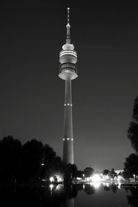 Low angle view of illuminated tower against sky at night