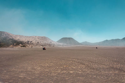 Scenic view of person travelling in the middle of desert