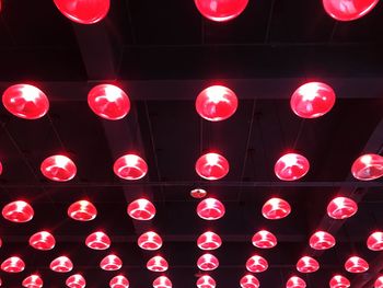 Low angle view of illuminated lanterns hanging at night