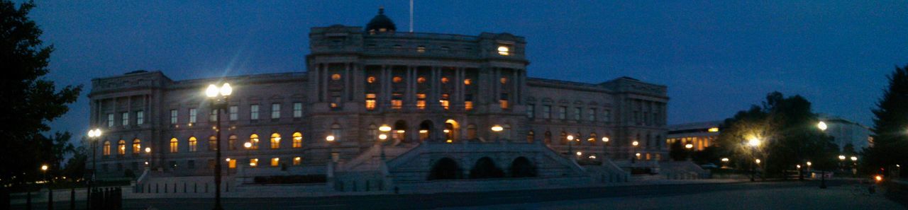 illuminated, night, building exterior, architecture, built structure, street light, clear sky, sky, lighting equipment, city, street, dusk, outdoors, building, low angle view, light - natural phenomenon, facade, dark, blue, no people