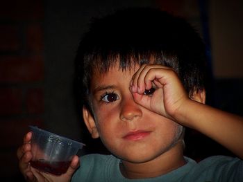 Close-up portrait of boy holding drink glass