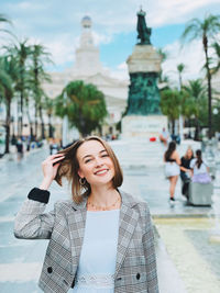 Portrait of young woman standing in the city of cadiz, spain .