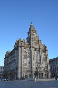 Low angle view of building against blue sky