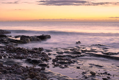 Scenic view of sea against sky during sunset