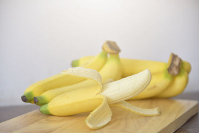 Close-up of fruits on cutting board against white background