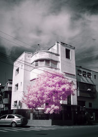 View of buildings against cloudy sky