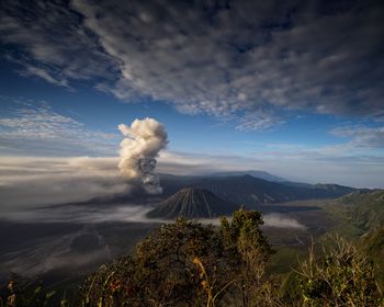 Smoke emitting from volcanic mountain against sky