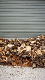 Stack of logs against wall