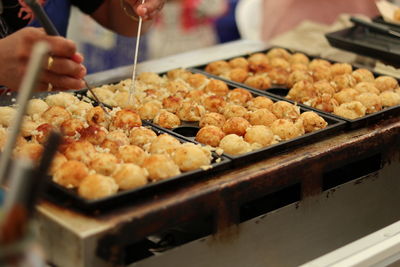 Cropped image of person having food in market