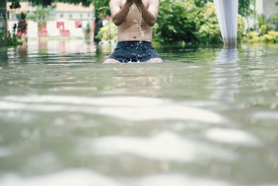 Low section of man in puddle