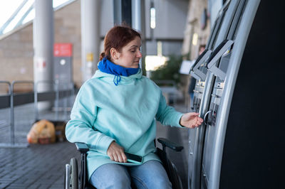 Portrait of young woman sitting in car