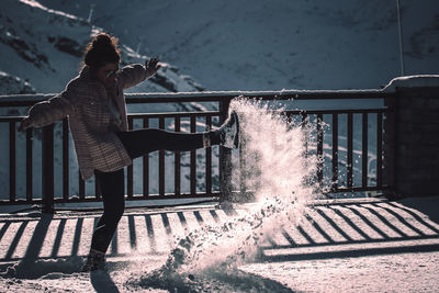 Rear view of man standing by railing