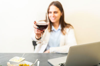 Young woman drinking glasses on table