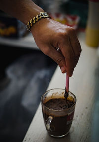 Close-up of hand holding coffee