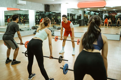 Rear view of woman standing in gym