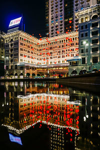 Reflection of building in city at night