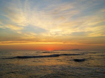 Scenic view of beach against sky during sunset