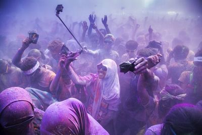 Crowd playing holi