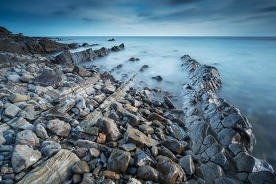 Scenic view of sea against cloudy sky