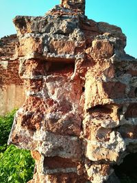 Low angle view of stone wall against sky