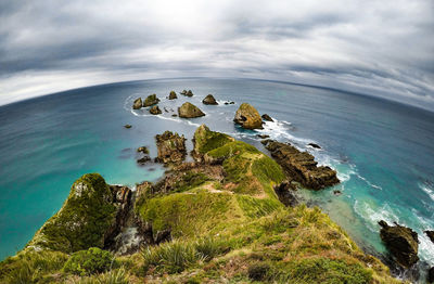 Rock formations by sea against sky