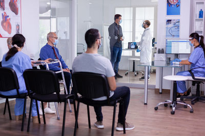 Rear view of business colleagues working at gym