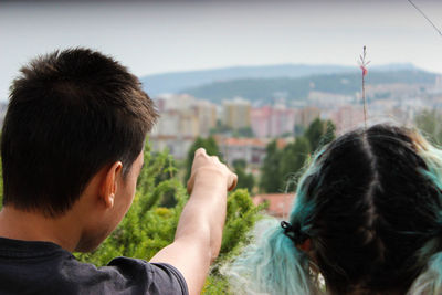 Rear view of woman looking at cityscape