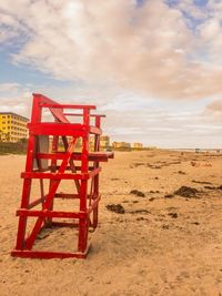 Lifeguard hut on beach against sky