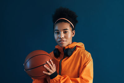 Side view of young man playing basketball