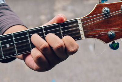 Cropped image of street musician playing guitar