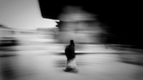 Rear view of man walking on beach