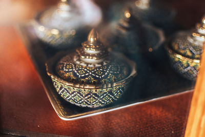 High angle view of antique containers in tray on table