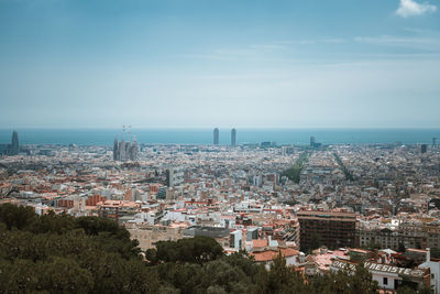 High angle view of townscape by sea against sky