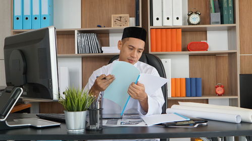 Portrait of young woman working in office