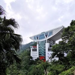 Low angle view of trees and buildings against sky