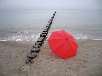 High angle view of red umbrella on beach