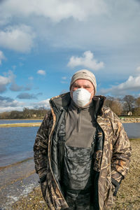 Photo with a portrait of a man, on the face is a protective mask, spring