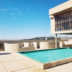 Swimming pool against clear blue sky