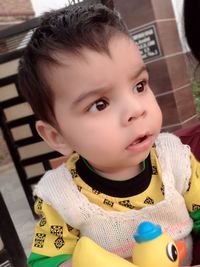 Close-up portrait of cute boy at home