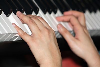 Cropped hand playing piano