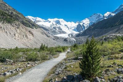 Scenic view of snow covered mountain against clear blue sky