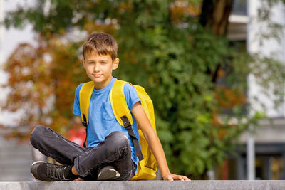 Portrait of boy sitting outdoors