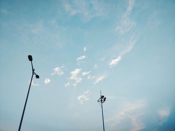 Low angle view of street lights against sky