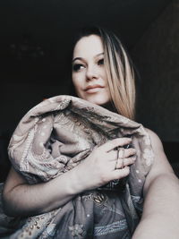 Portrait of beautiful woman against black background