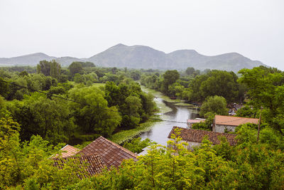 High angle view of trees and mountains against clear sky