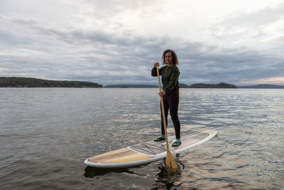 Full length of man standing on boat against sky