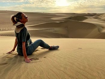 Side view of man on sand dune