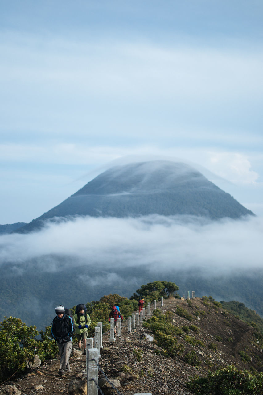 mountain, scenics, sky, landscape, mountain range, fog, cloud - sky, tranquility, beauty in nature, tranquil scene, travel destinations, nature, tourism, famous place, weather, travel, non-urban scene, physical geography, cloudy, religion